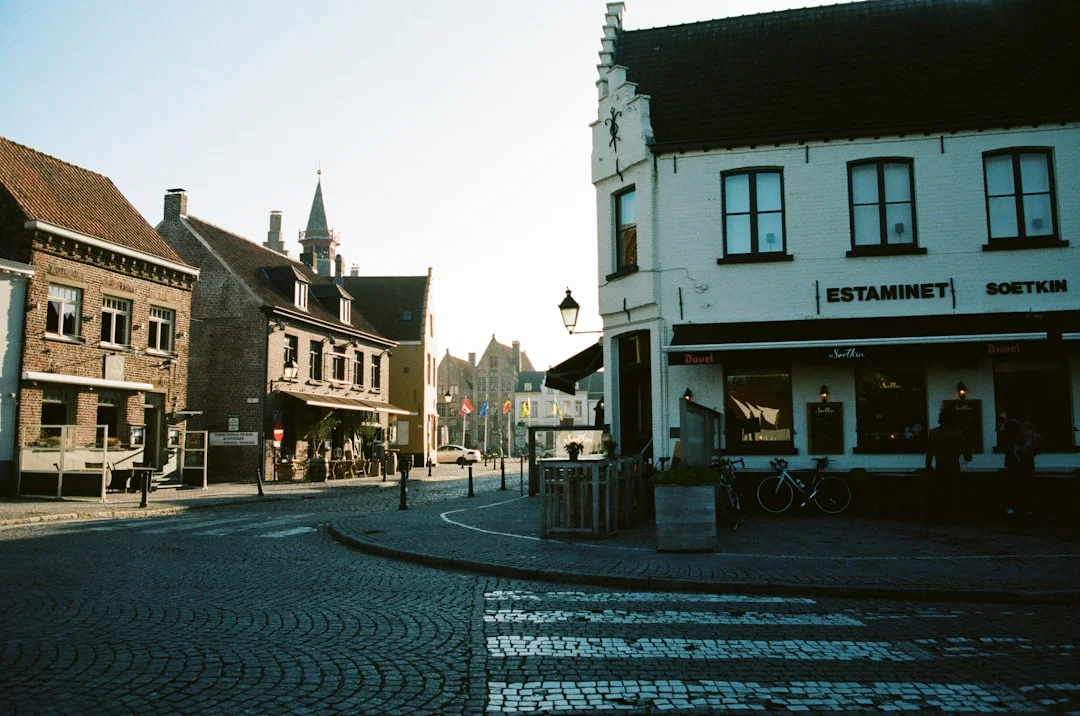 A quiet village square in the early morning, before the day's activities begin